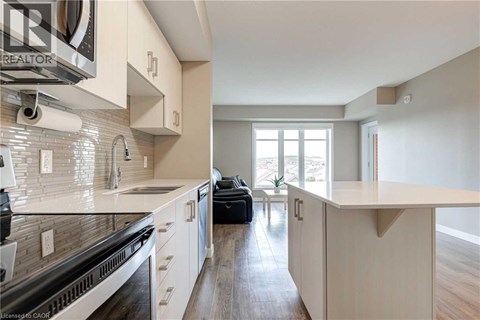 A modern kitchen with white cabinets and a large island.