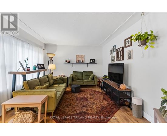 A living room with a green couch and a television.