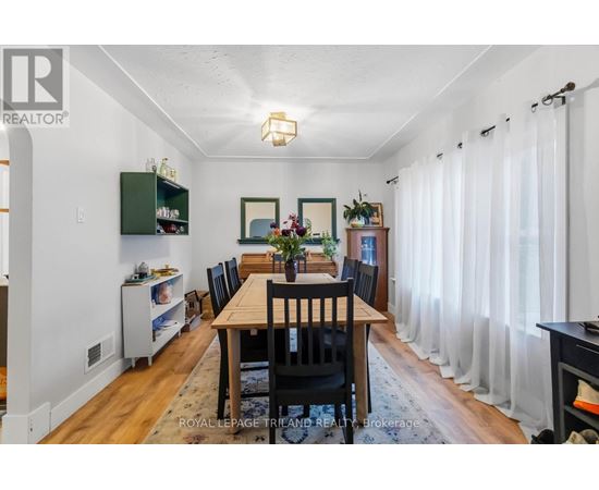 A dining room with a wooden table and chairs.