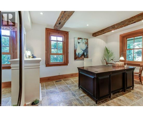 A room with a wooden cabinet and a painting on the wall.