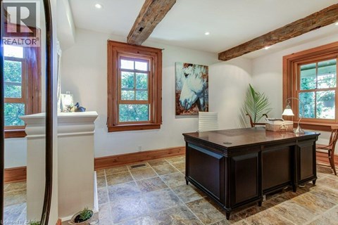 A room with a wooden cabinet and a painting on the wall.
