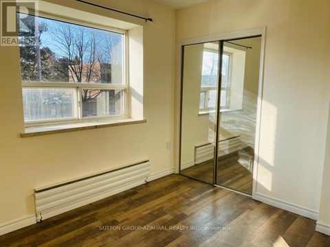 A room with a window and a sliding door.