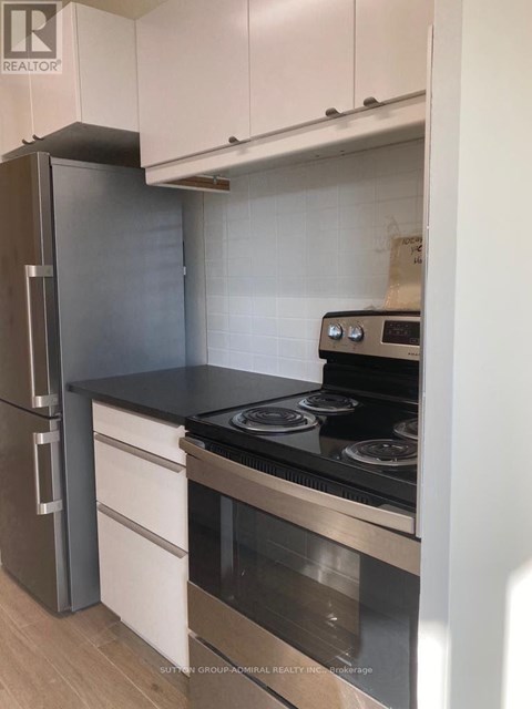 A kitchen with a stove and a refrigerator.