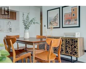 A dining room with a table and chairs.