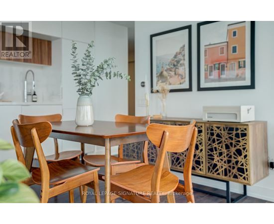 A dining room with a table and chairs.