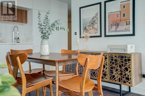 A dining room with a table and chairs.