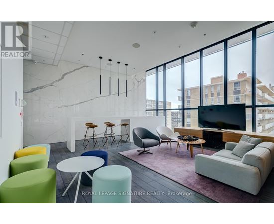 A living room with a white couch and a TV.
