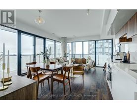 A modern kitchen with a dining table and chairs.