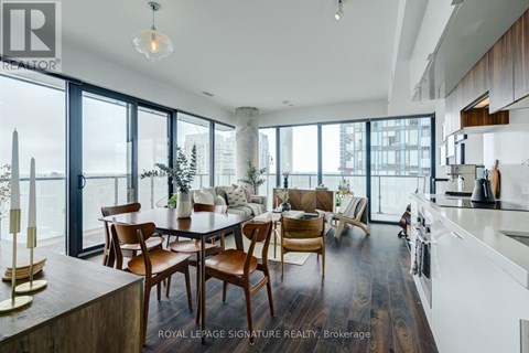 A modern kitchen with a dining table and chairs.