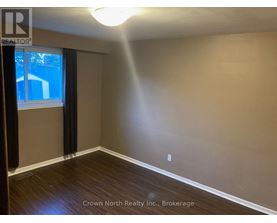 A room with Crown North Realty Inc. logo and Brokerage written on the wall.