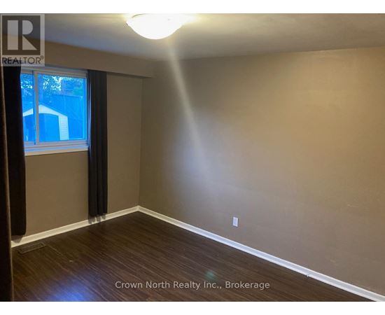 A room with Crown North Realty Inc. logo and Brokerage written on the wall.