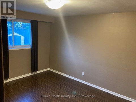 A room with Crown North Realty Inc. logo and Brokerage written on the wall.