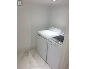 A white washer and dryer in a small laundry room.