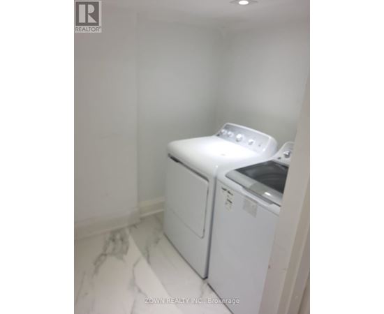 A white washer and dryer in a small laundry room.