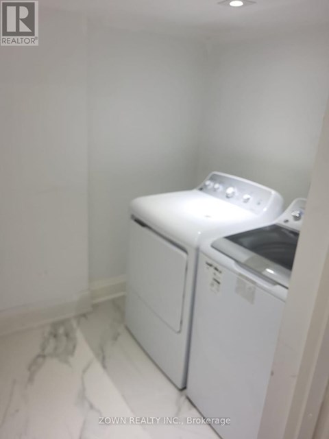 A white washer and dryer in a small laundry room.