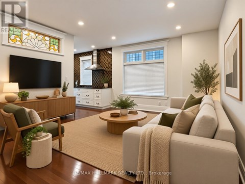 A living room with a couch, a chair, a coffee table, and a television.
