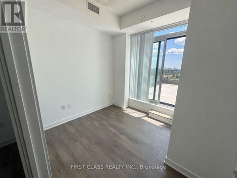 A room with a view of the city through the window.