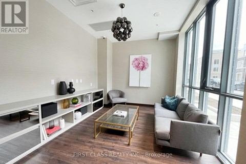 A living room with a couch, a coffee table, and a chandelier.