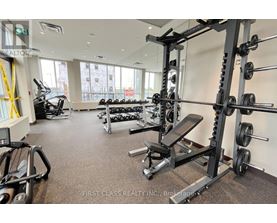 A gym with a variety of equipment including weights and cardio machines.
