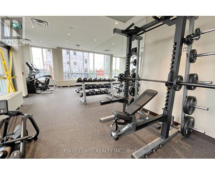 A gym with a variety of equipment including weights and cardio machines.