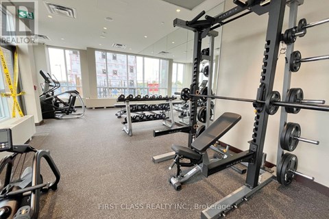 A gym with a variety of equipment including weights and cardio machines.