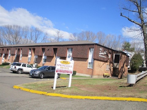 A building with a sign that says Springhill Estates in front of it.