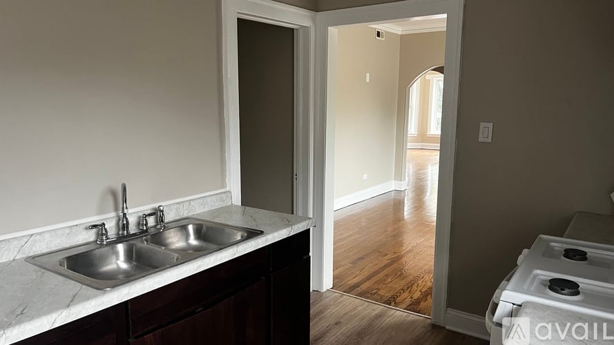 A kitchen with a sink and a stove top oven.