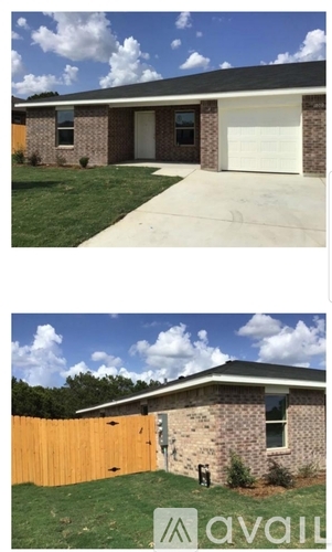 A house with a white garage door and a brown fence.