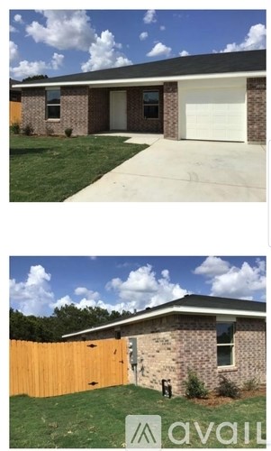 A house with a white garage door and a brown fence.