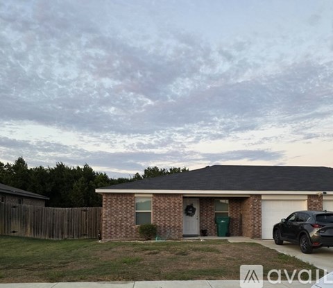 A house with a black car parked in front.