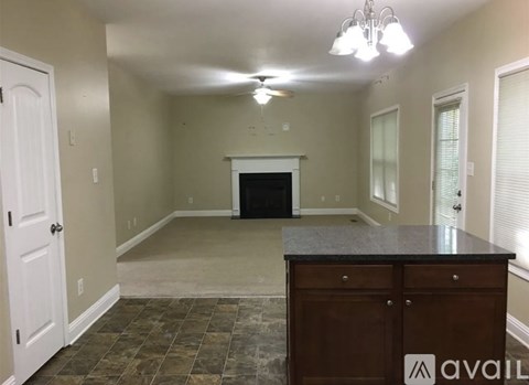 A room with a fireplace and a counter.