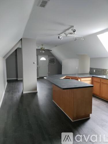 A kitchen with a wooden island in the middle of the room.