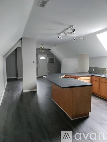 A kitchen with a wooden island in the middle of the room.