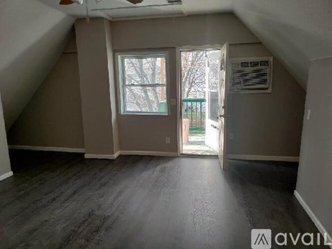 A room with a window and a door leading outside.
