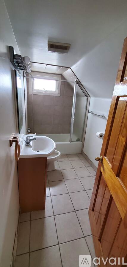 A bathroom with a sink, toilet, and shower.
