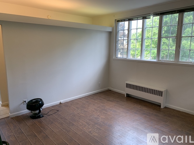 A room with a fan and a window.
