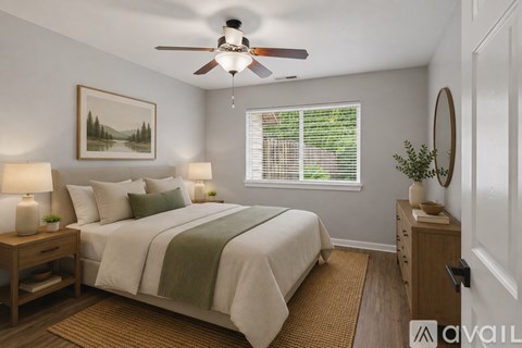 A bedroom with a bed, a ceiling fan, and a window with blinds.