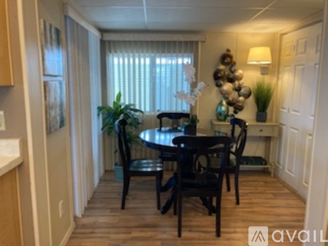 A dining room with a table set for four.