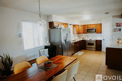A kitchen with a refrigerator, oven, and sink.