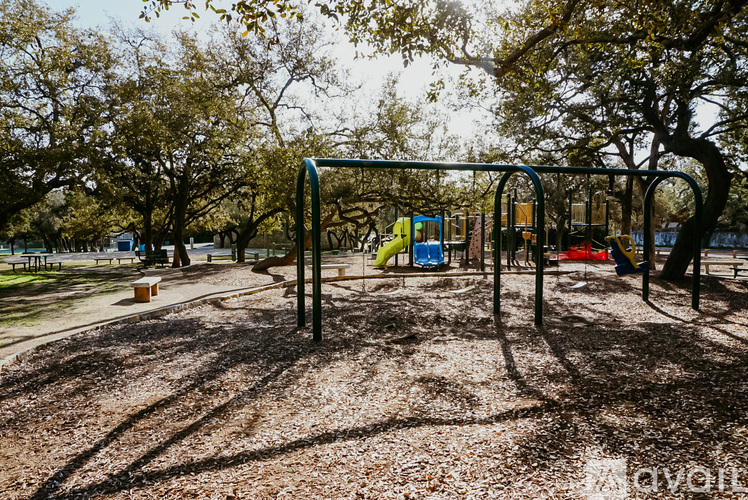 A playground with a swing set and a slide.