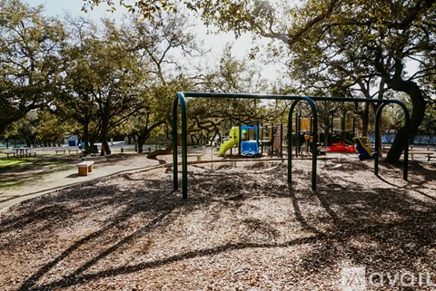 A playground with a swing set and a slide.