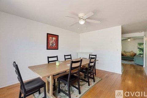 A dining room with a table and chairs.