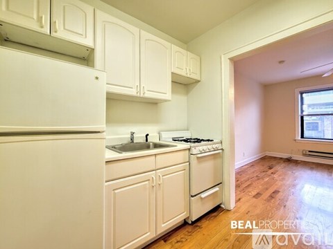 A kitchen with white appliances and cabinets.