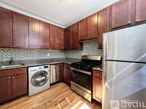 A kitchen with wooden cabinets and a white refrigerator.