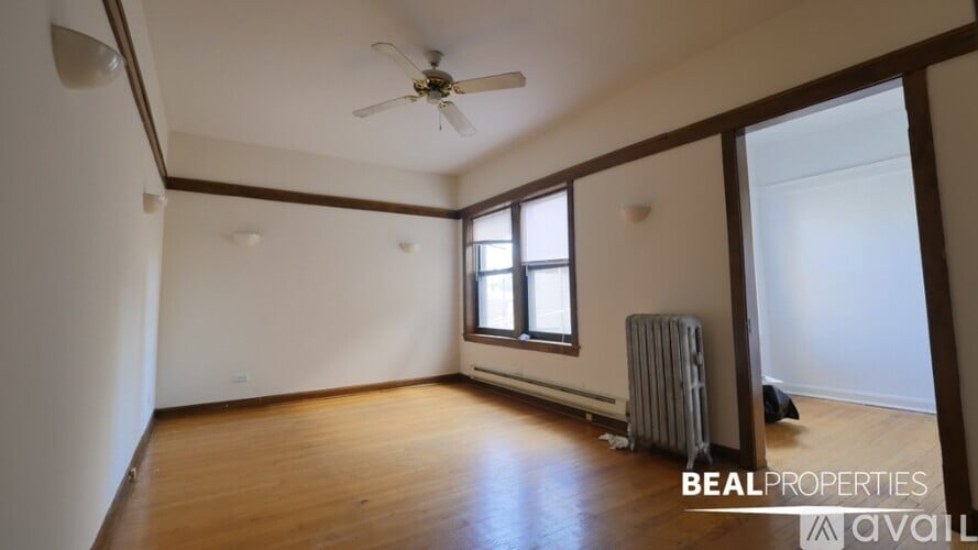 A room with a ceiling fan and a window.