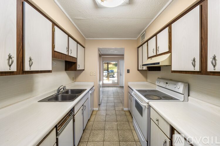 A kitchen with white cabinets and appliances.