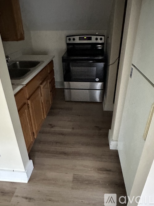 A kitchen with a stove, oven, and sink.