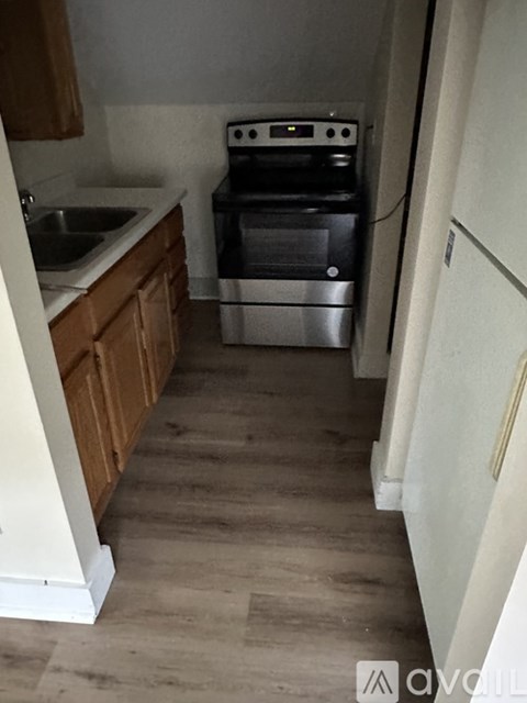 A kitchen with a stove, oven, and sink.