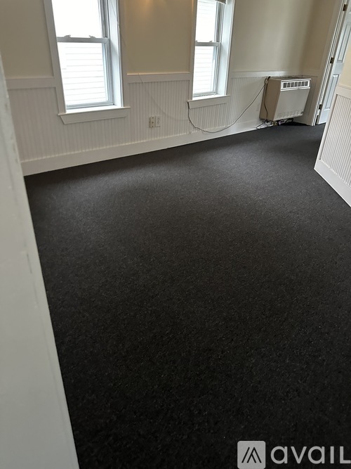 A room with a black floor and white walls.