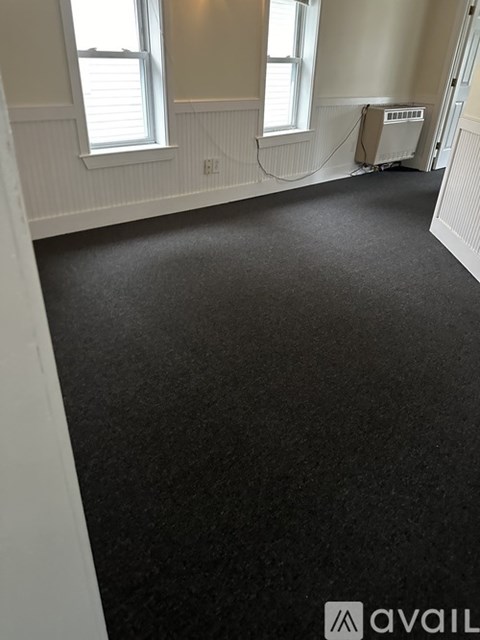 A room with a black floor and white walls.